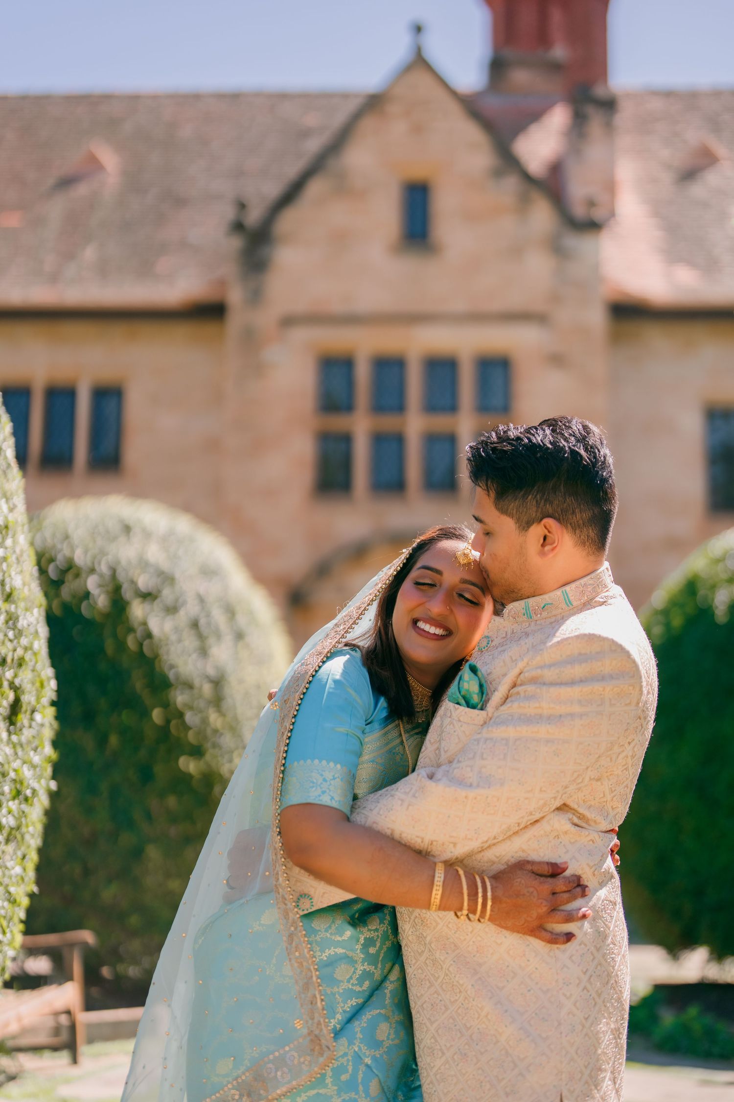 Romantic embrace in front of the sandstone manor at Carrick Hill, Springfield, Adelaide