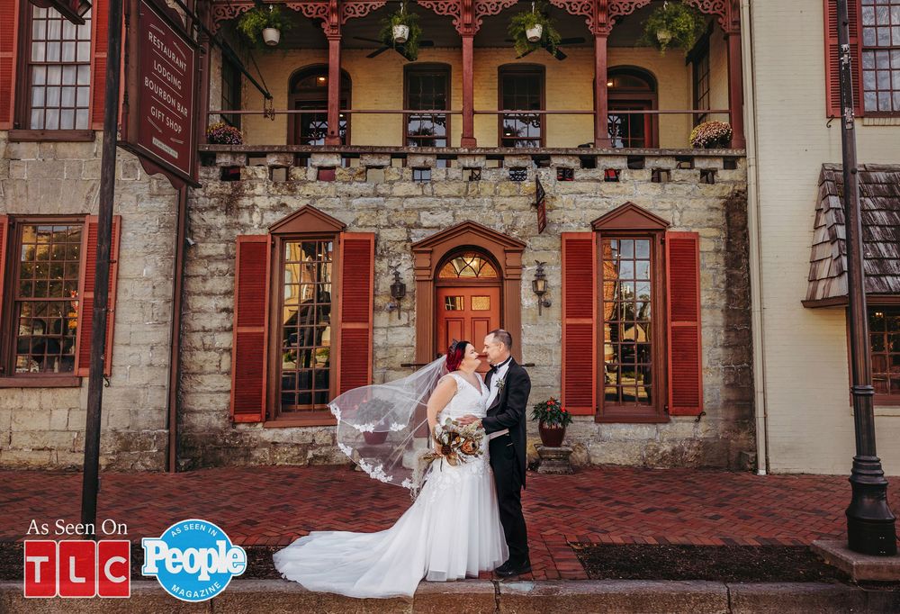 Amy Halterman and Brian Lovvorn on their wedding day posing in front of Talbott Tavern after their wedding ceremony
