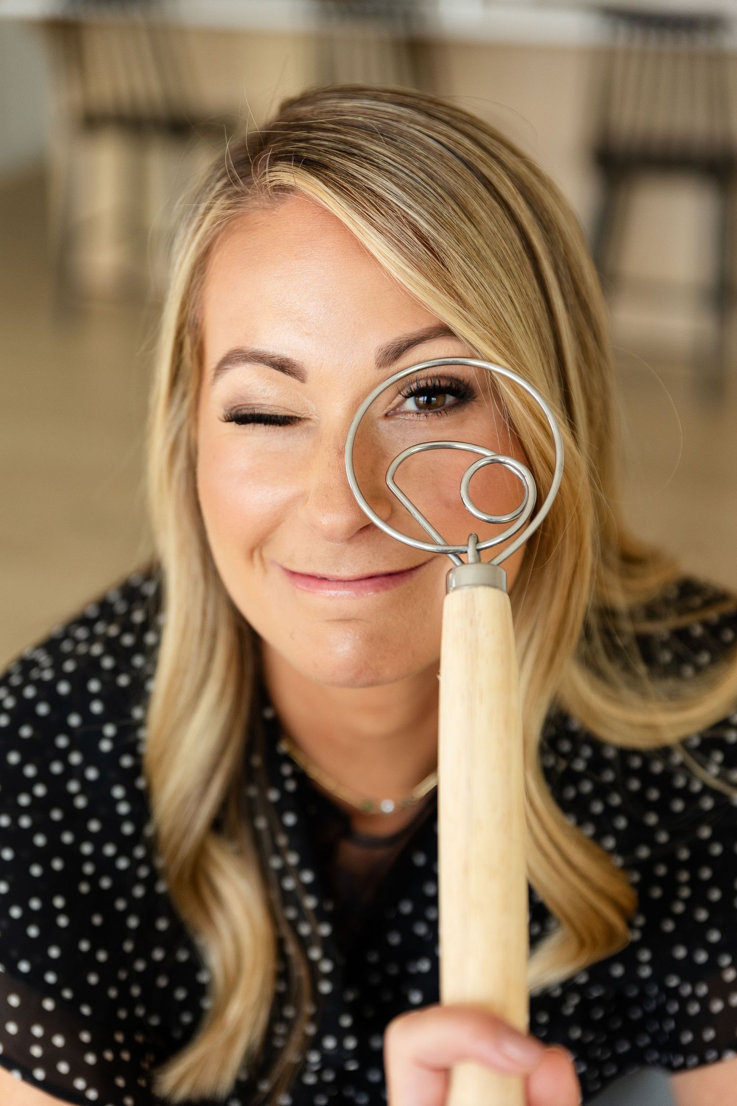 woman holding her dough whisk for her business photo session