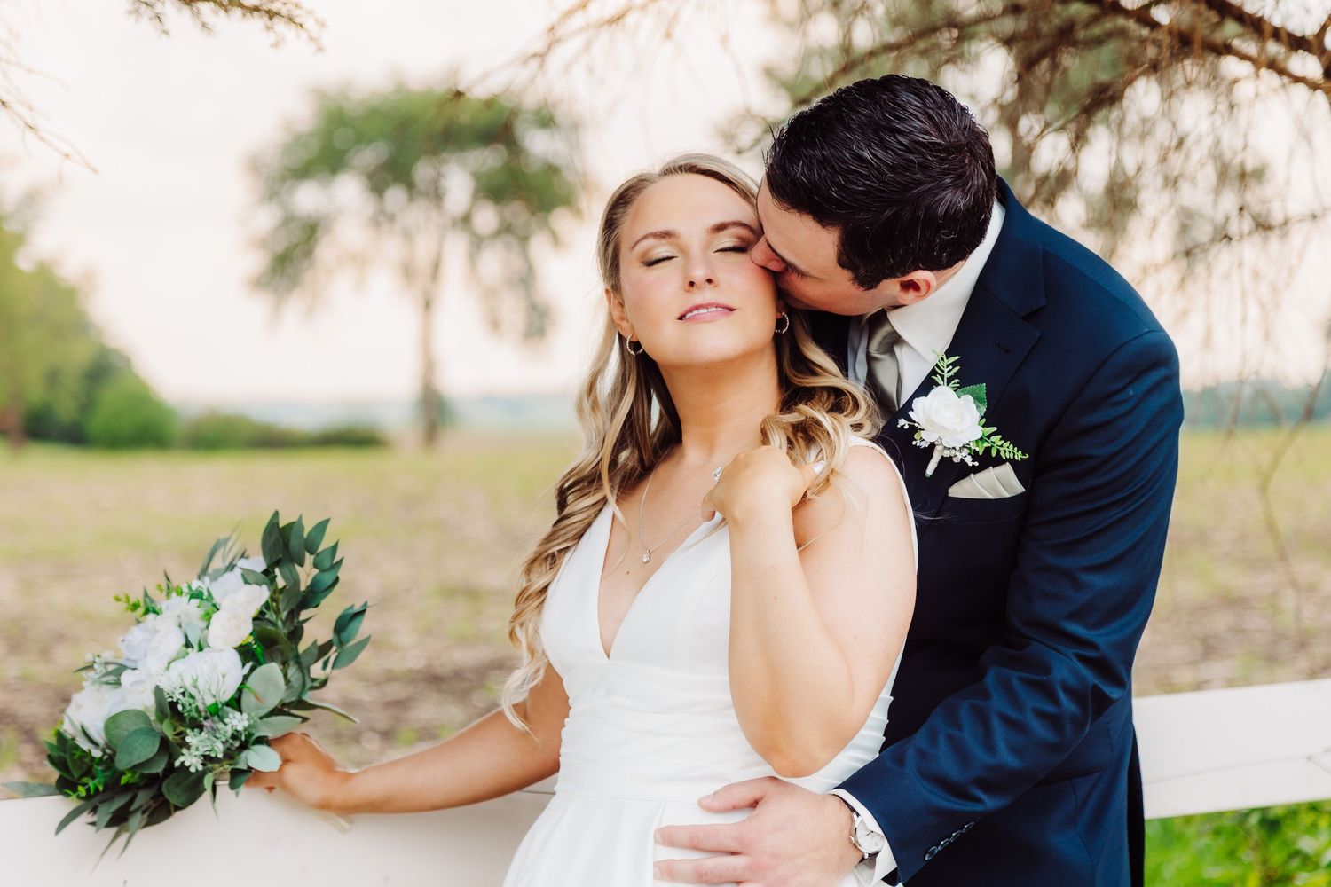 Groom kissing bride at Next Chapter Winery in New Prague Minnesota