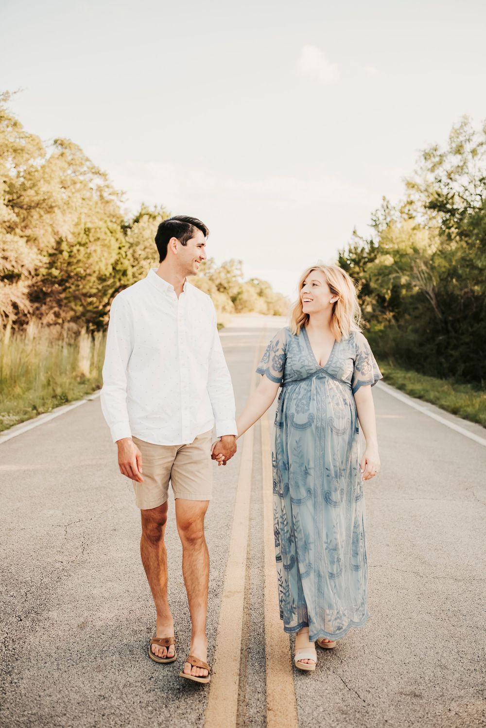 Maternity couple posing closely during a sunset photoshoot.
