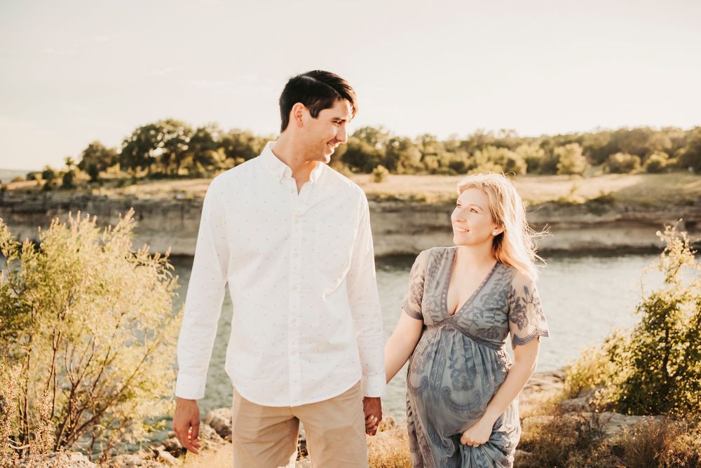 Outdoor maternity session with a glowing pregnant woman at sunset.