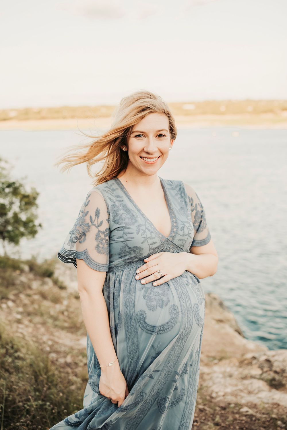 Outdoor maternity session with a glowing pregnant woman at sunset.