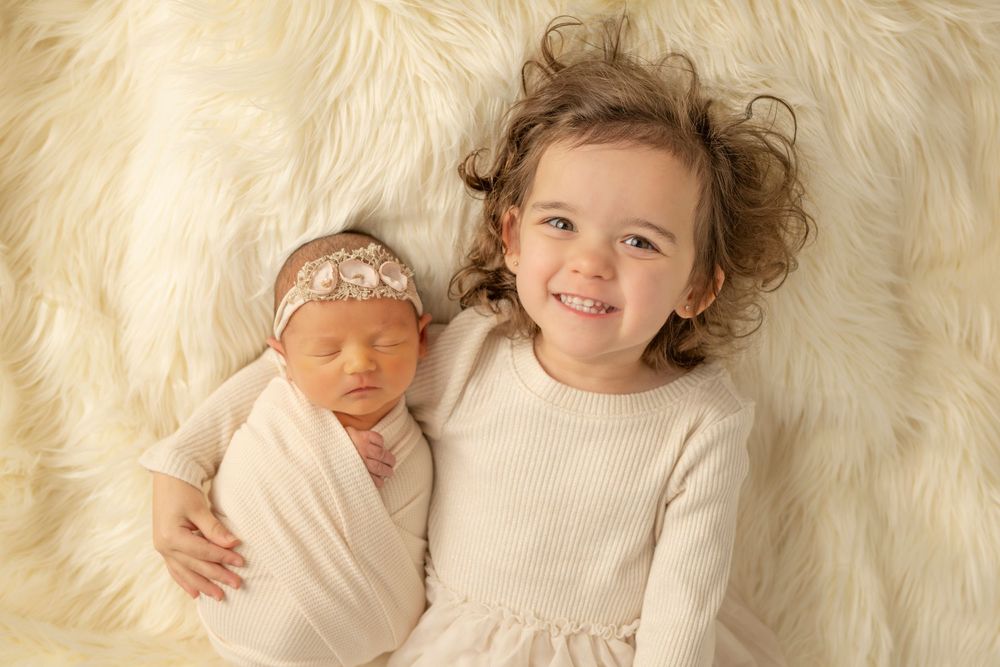 A series of four connected photos showing children lying on white fur blankets with curly hair and happy expressions.