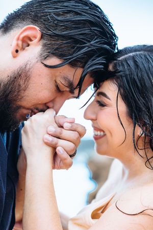 A romantic couple with wet hair share intimate moments in a series of close-up photos.