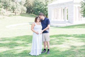 A couple shares romantic moments together against a bright sunny background in a garden setting.