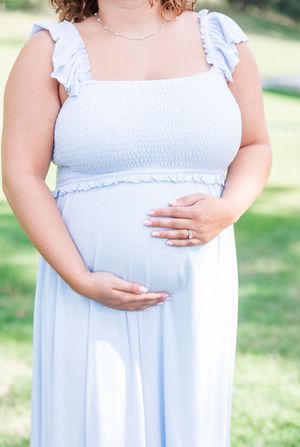A collaged series of maternity photos showing a pregnant person in a light blue dress outdoors.