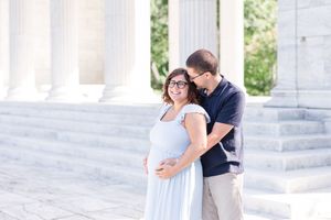 A romantic sequence of photos showing a couple embracing on a light stone colonnade with white pillars.
