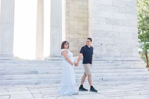 A happy couple shares a special moment at the Jefferson Memorial in Washington DC on a sunny day.
