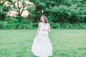 Multiple frames show a family joyfully posing together on a green lawn during a summer photo session.