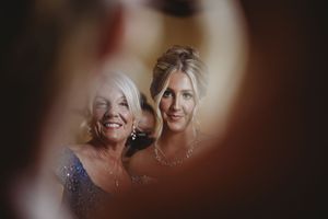 Soft focus emotional moment captured during wedding preparations.