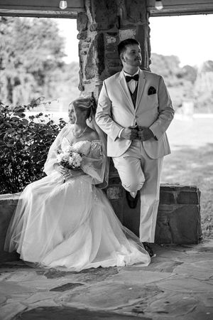 Black and white wedding portraits showing tender moments between newlyweds on stone steps.