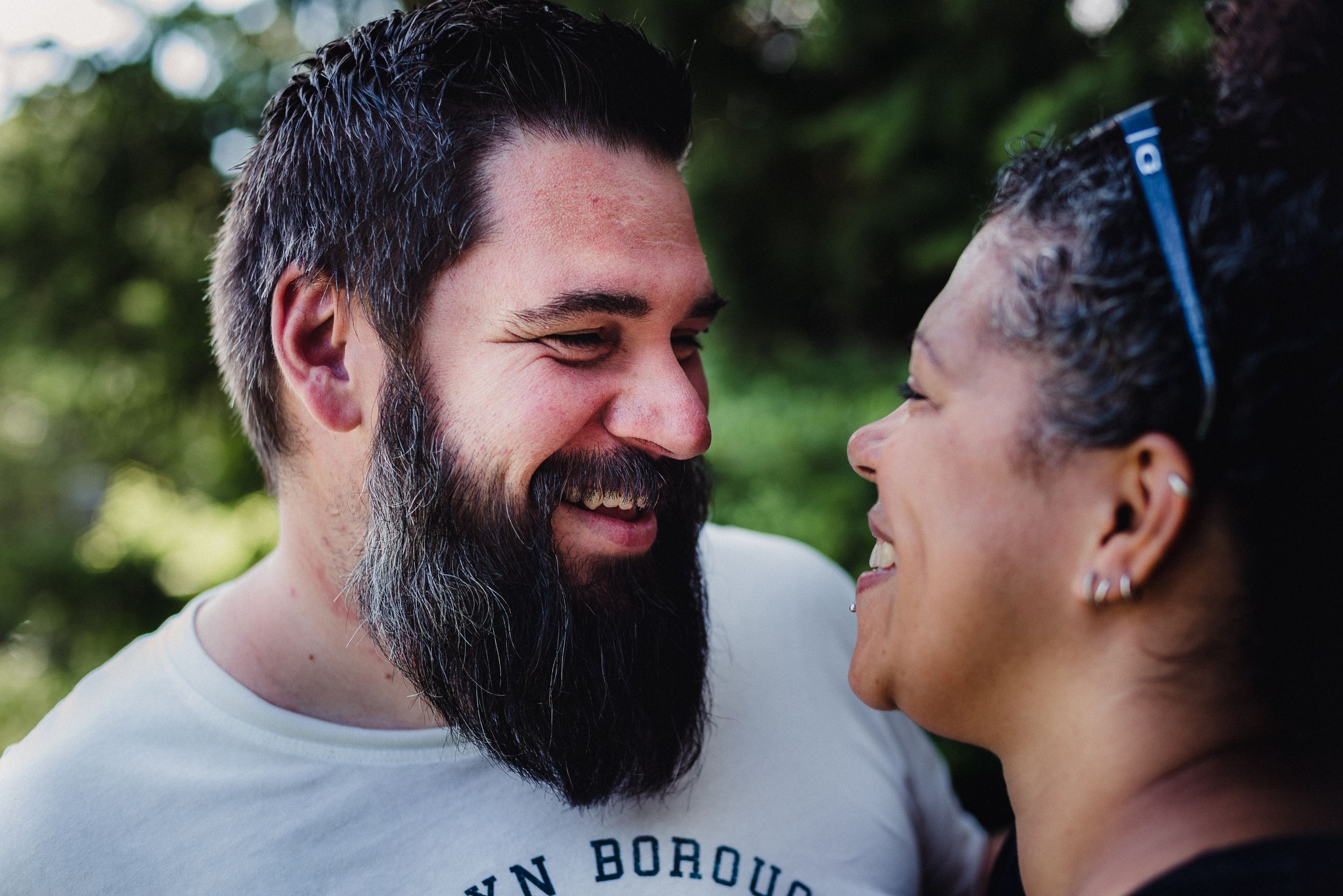 Colour image of a man smiling at a woman.