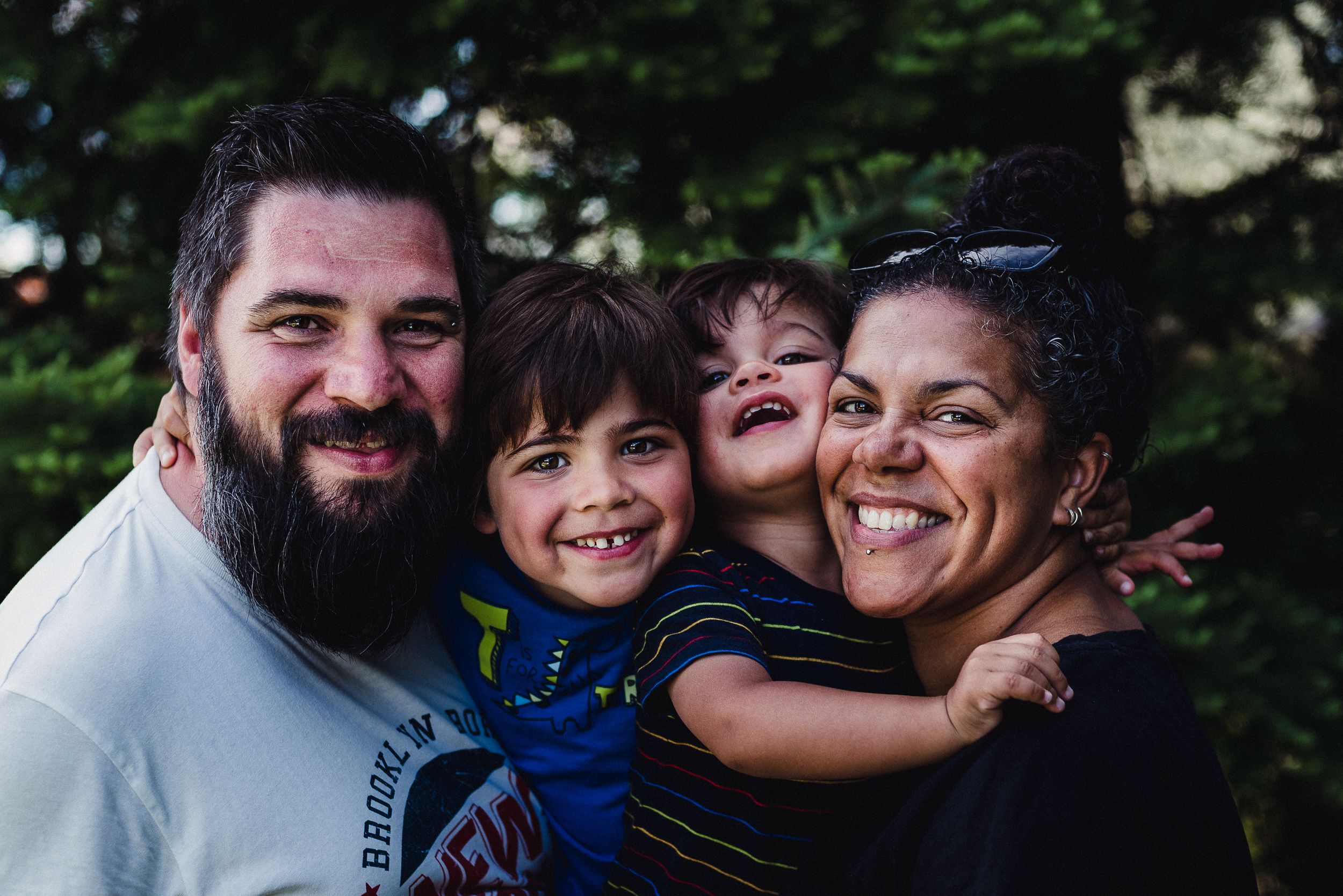 Colour family portrait of a man, woman and 2 young children.
