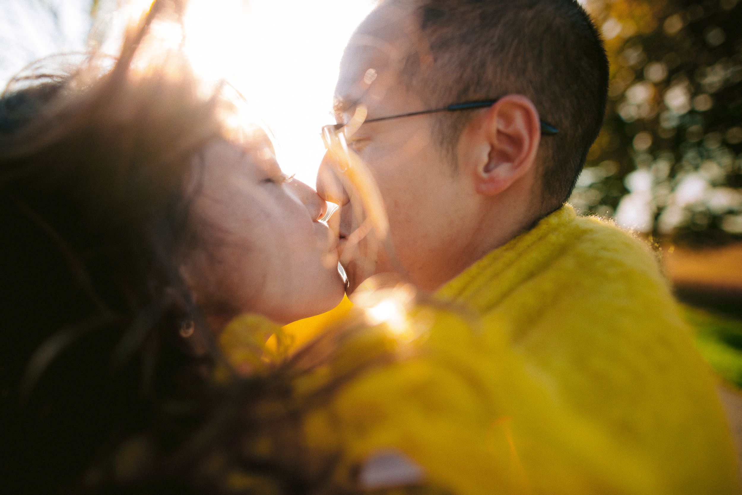 A tender moment captured in warm sunlight with a yellow jacket.