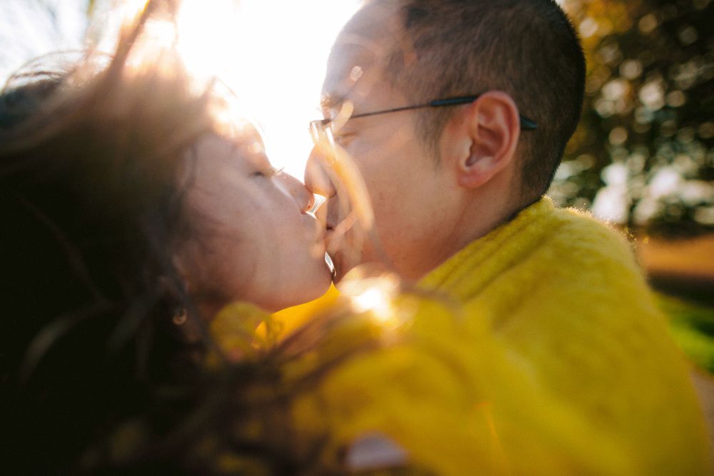 A tender moment captured in warm sunlight with a yellow jacket.