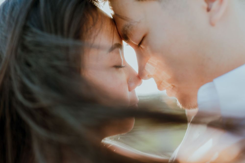 An intimate close-up moment captured with soft natural lighting and gentle shadows.