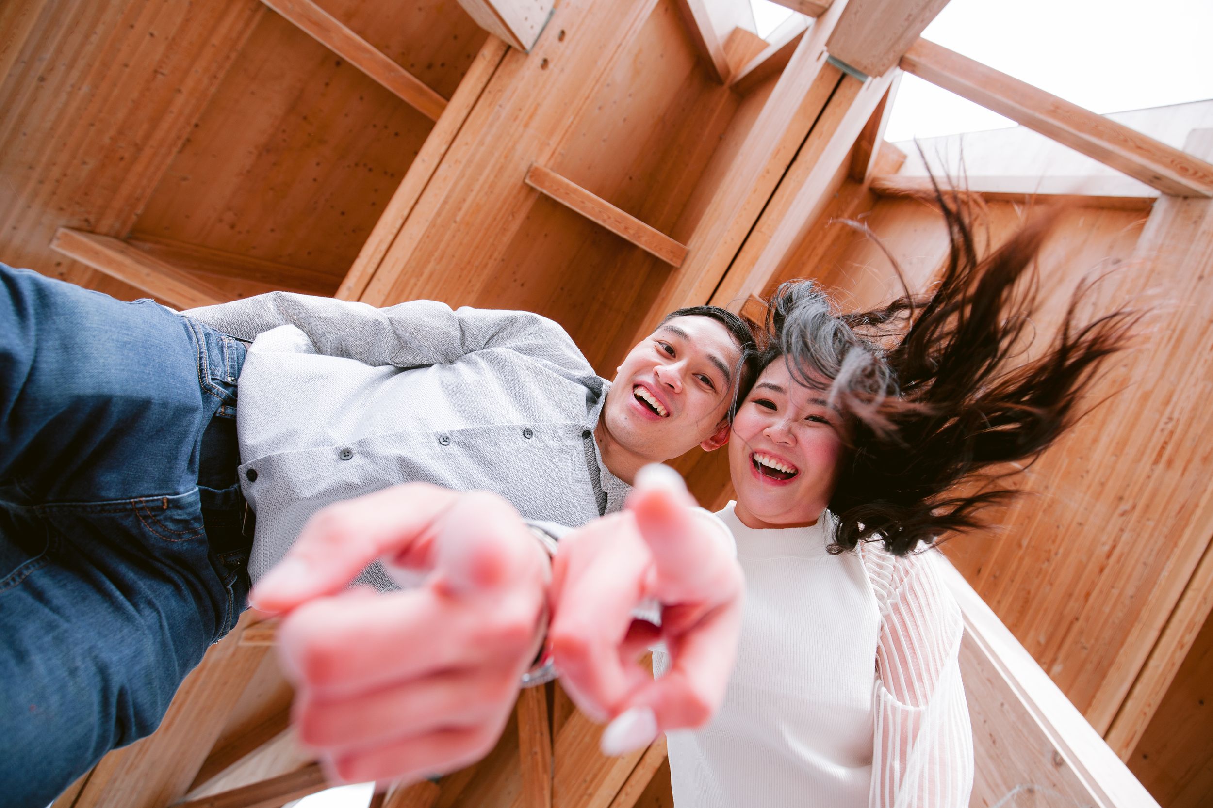 A candid moment of laughter captured from above on wooden flooring.