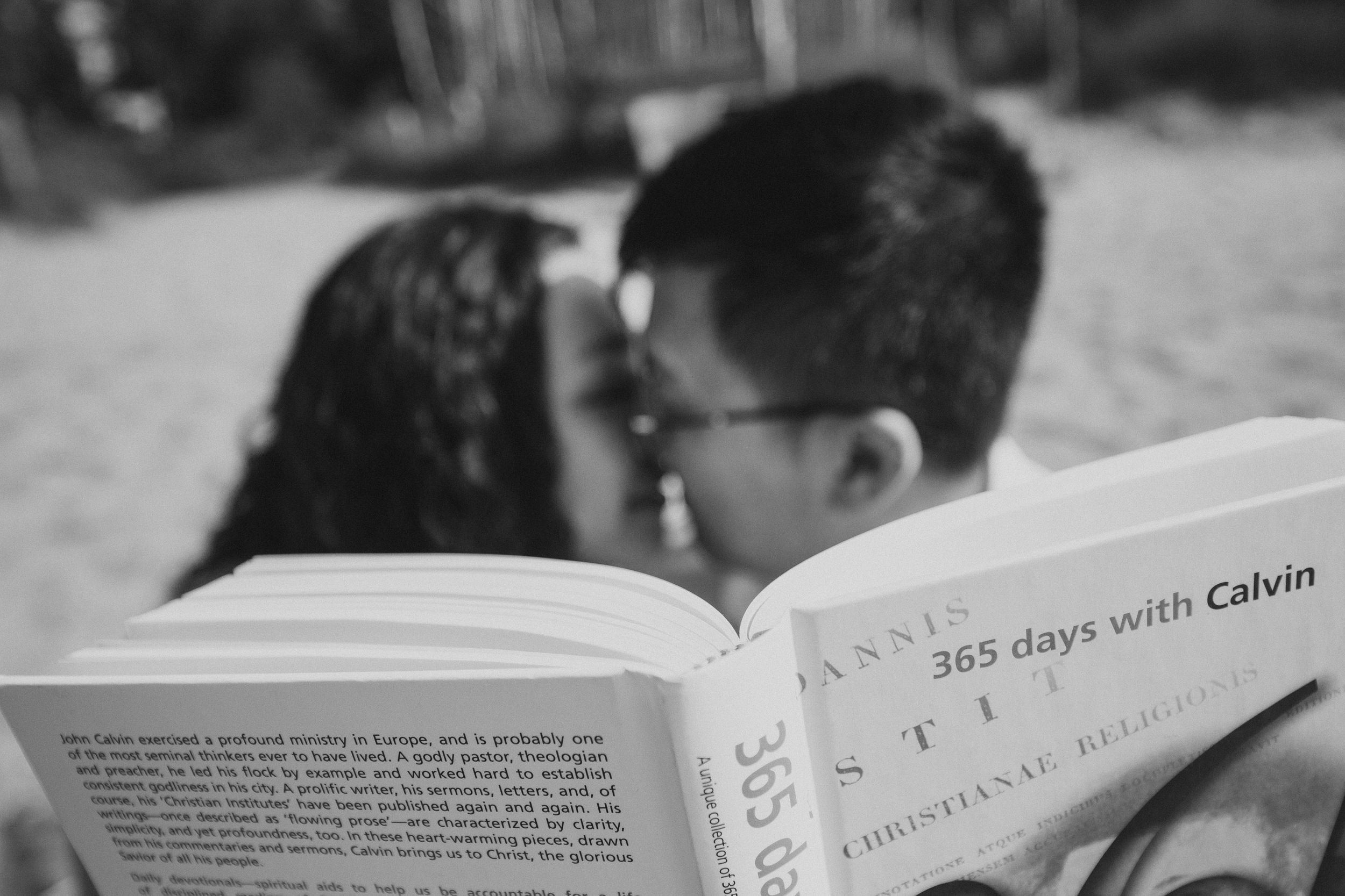 Close-up of couple sharing an intimate moment while reading a book together.