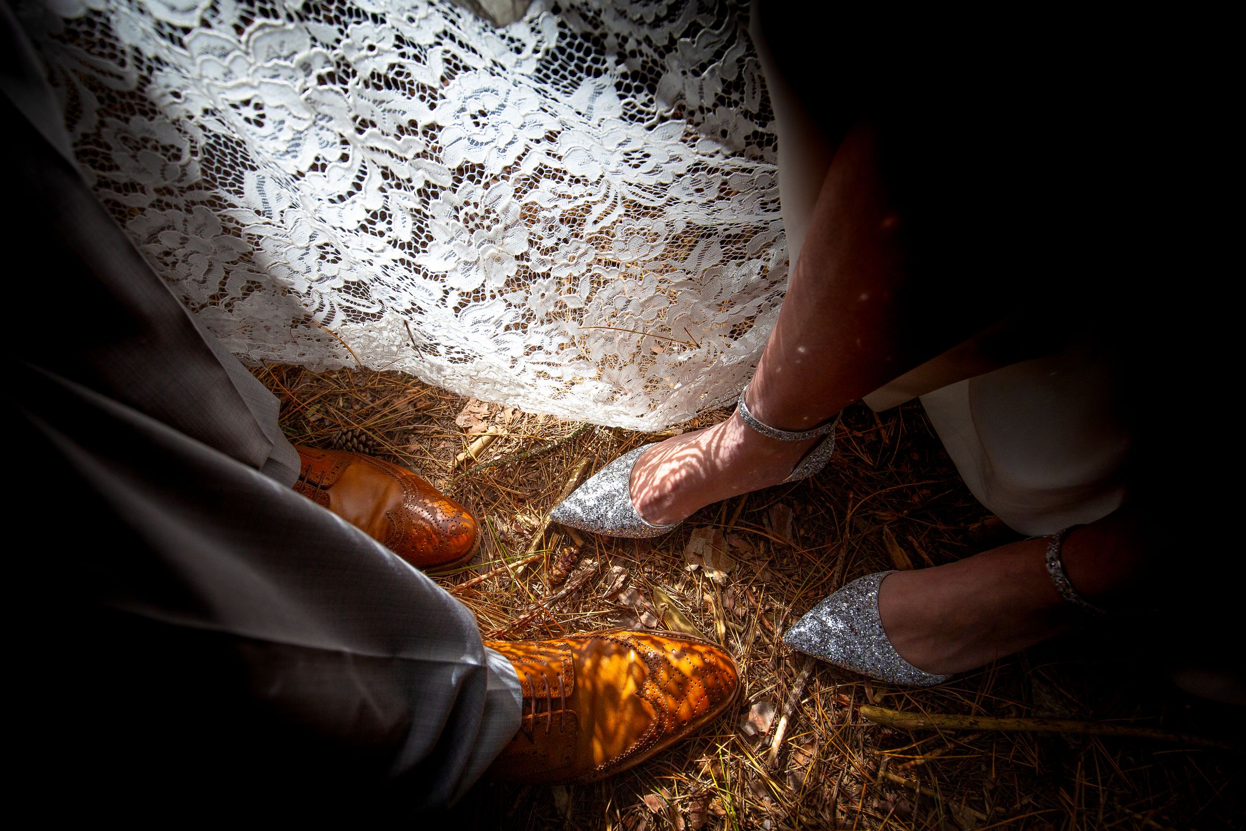 Hands digging in a dark cave with dramatic lighting illuminating the dirt and stones.