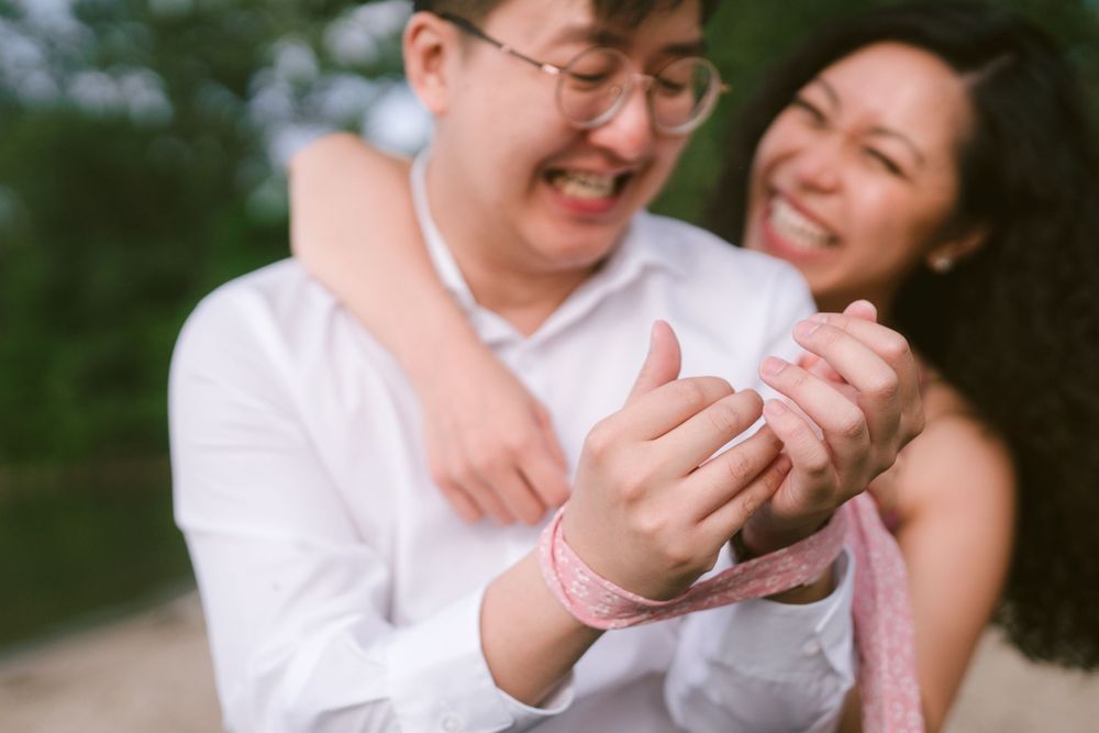A couple shares a joyful moment during their engagement photoshoot.