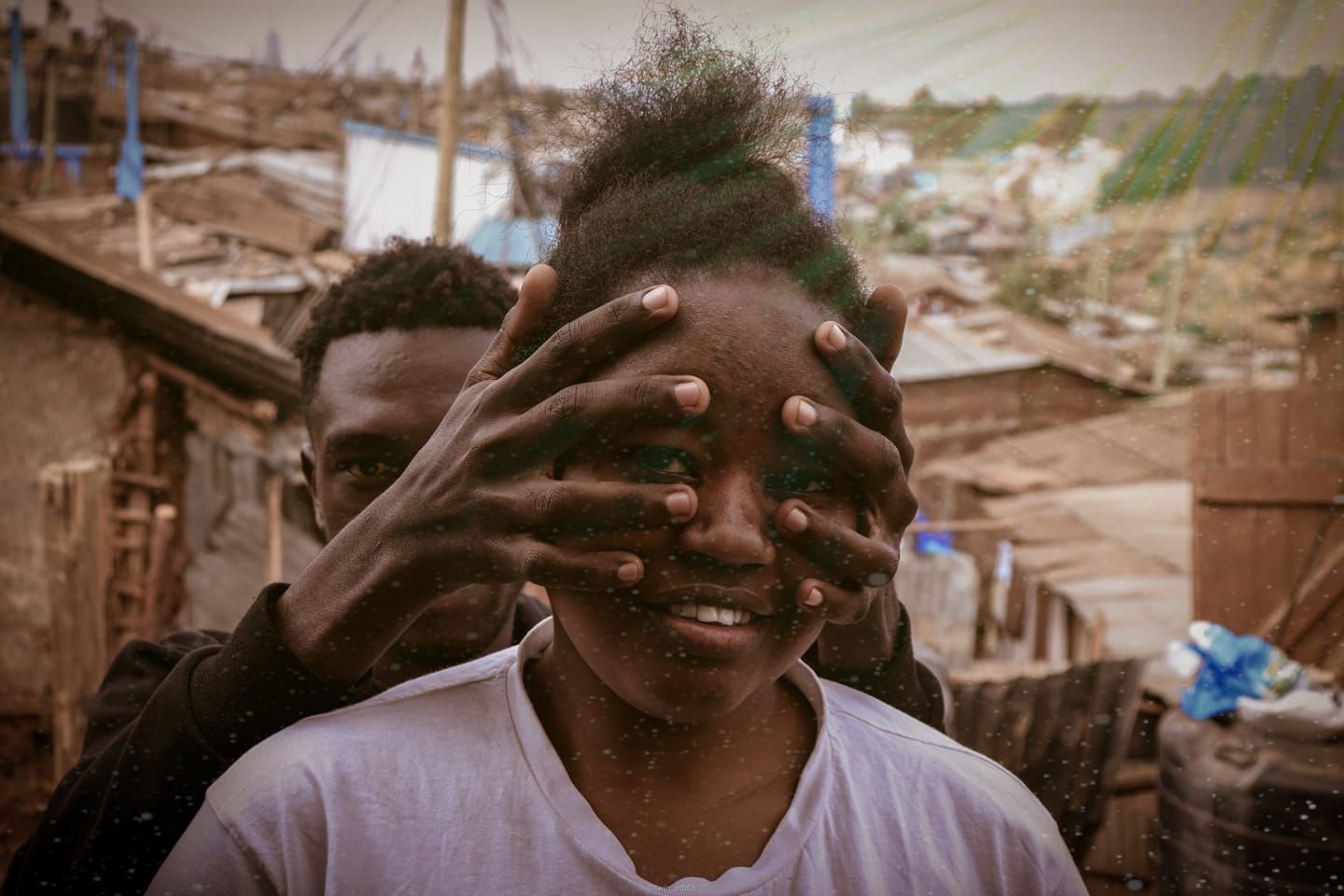 a couple with the man's hands on the woman's face during a photoshoot