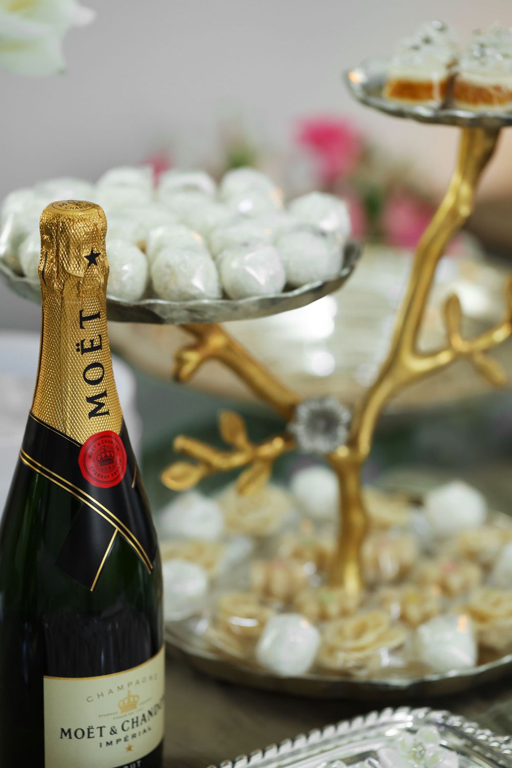 Close-up shots of Moet & Chandon champagne bottles on an elegant party table with decorative elements.