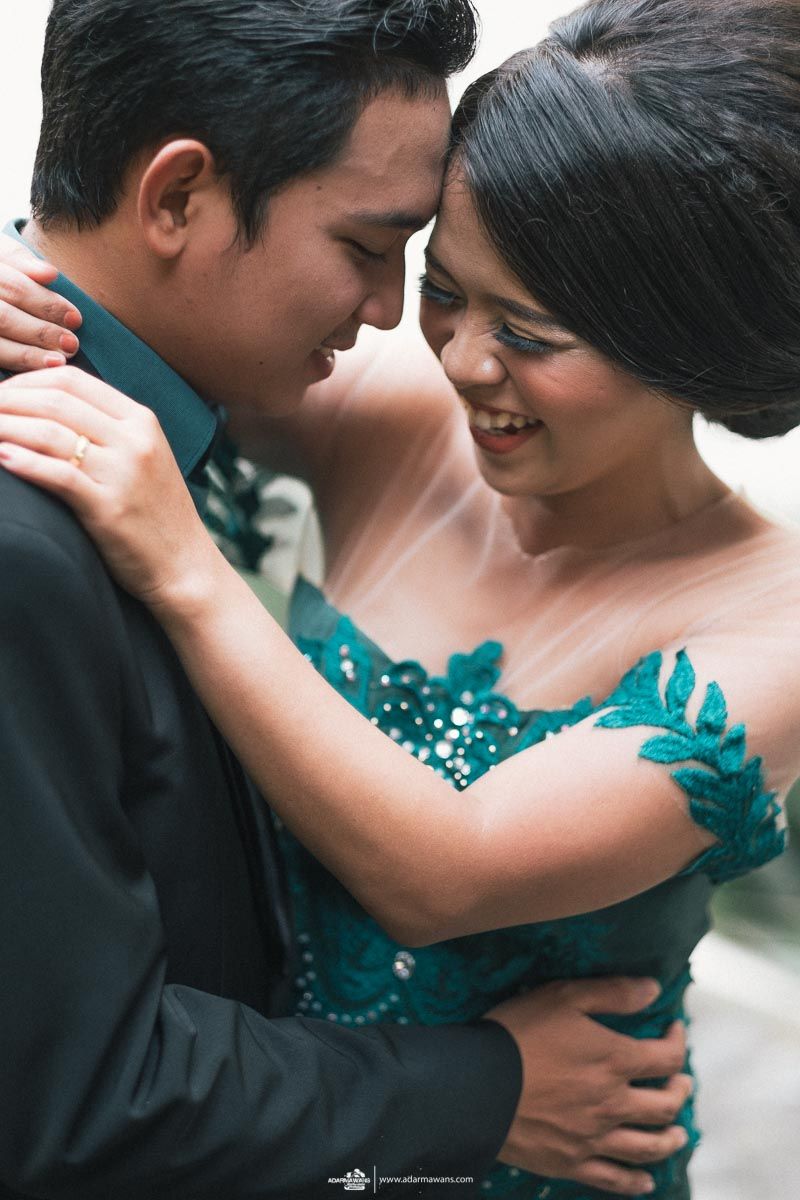 Intimate moment captured in formal wear with teal sequined details.