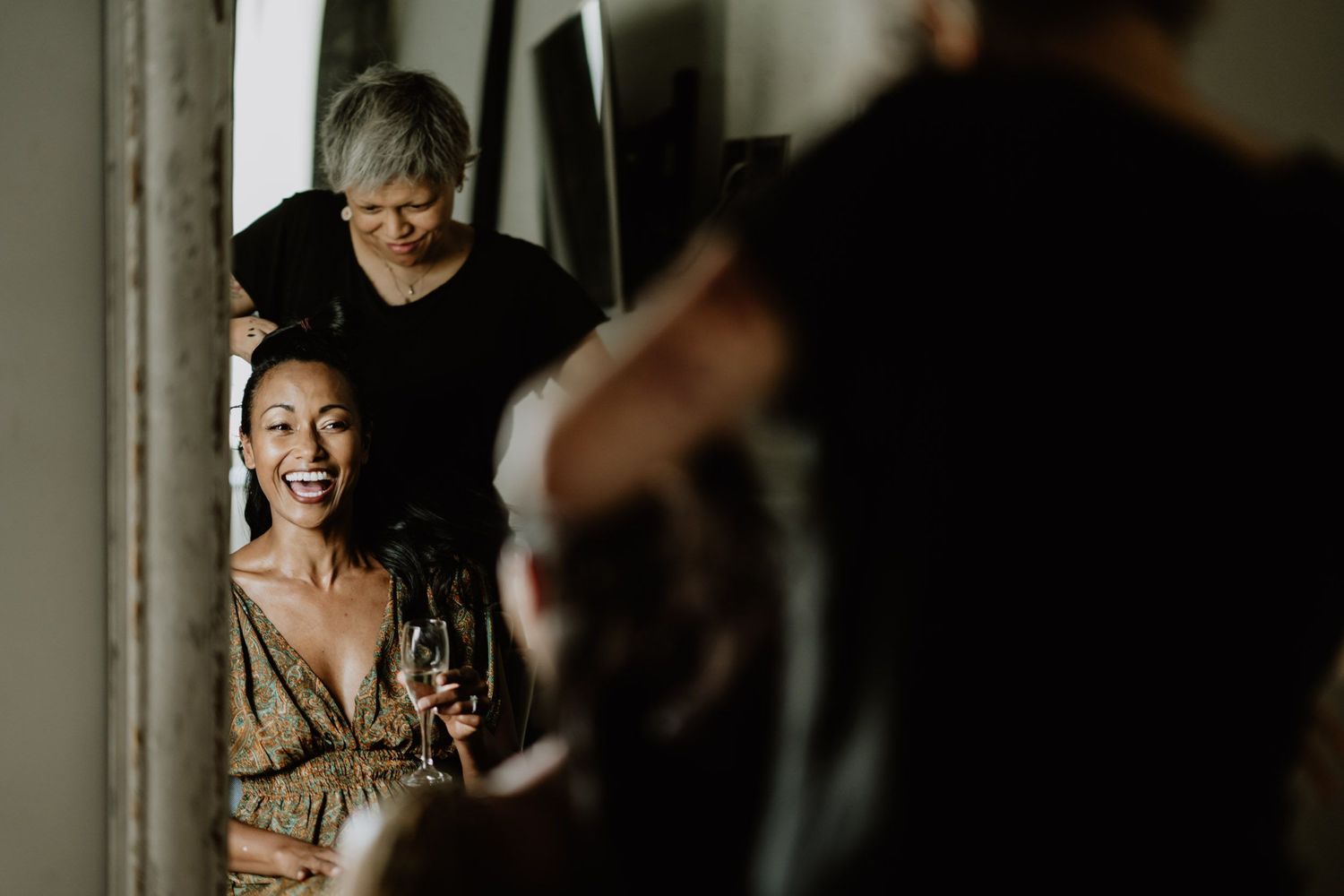 A candid moment of laughter captured during wedding preparations.
