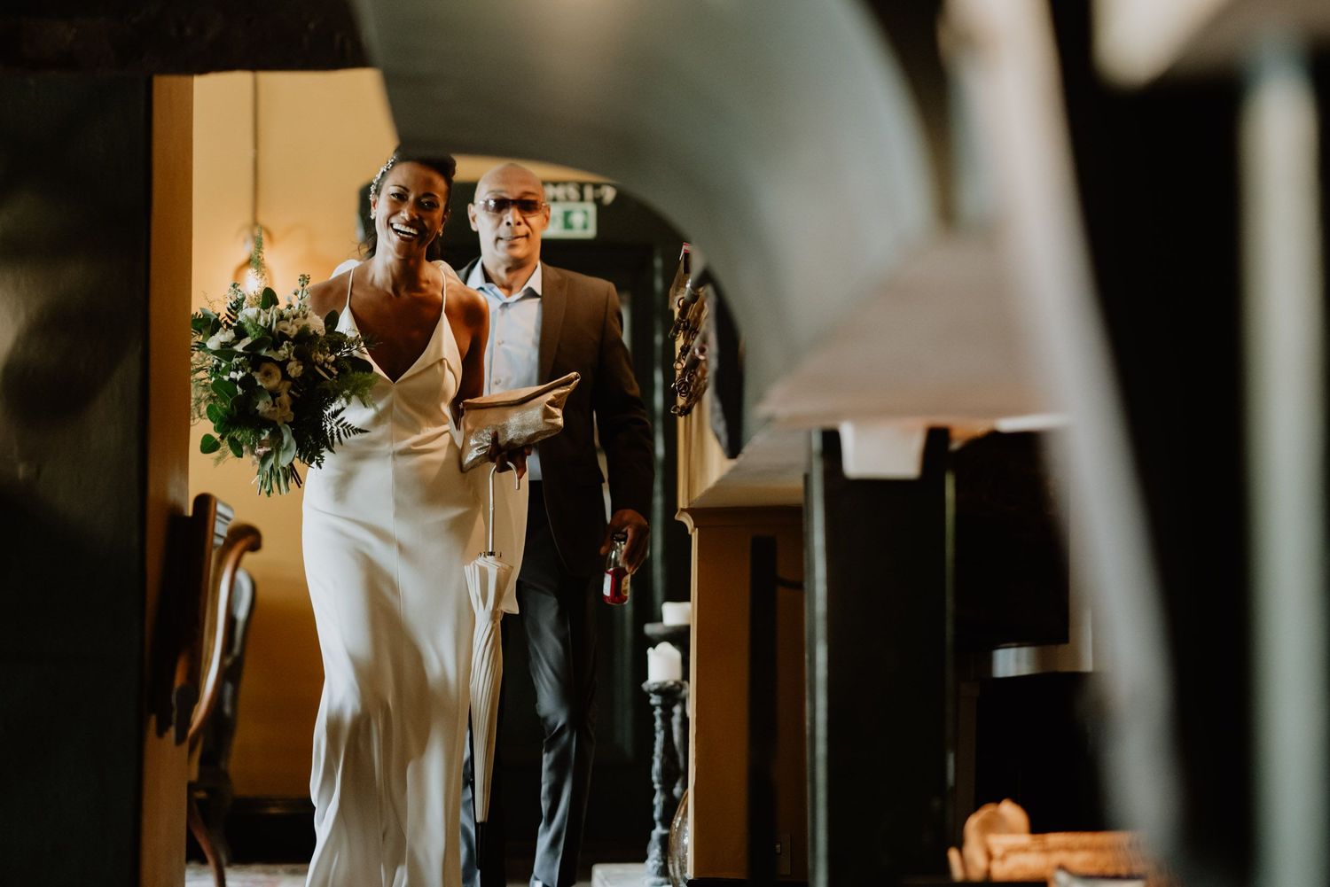 A bride admiring her reflection in a mirror during wedding preparations.