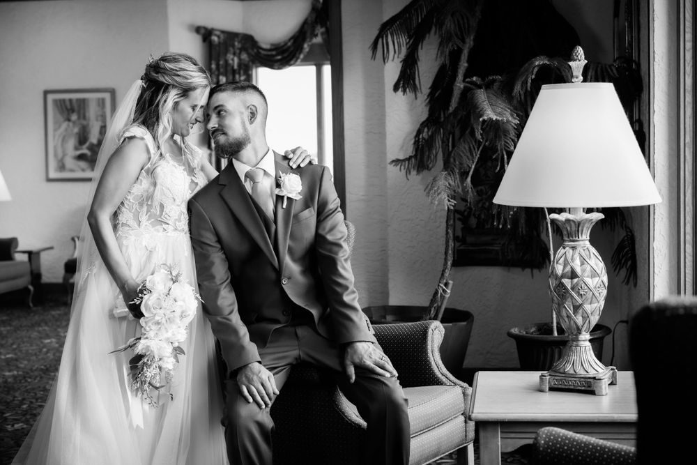 An intimate moment captured in black and white in an elegantly furnished room.