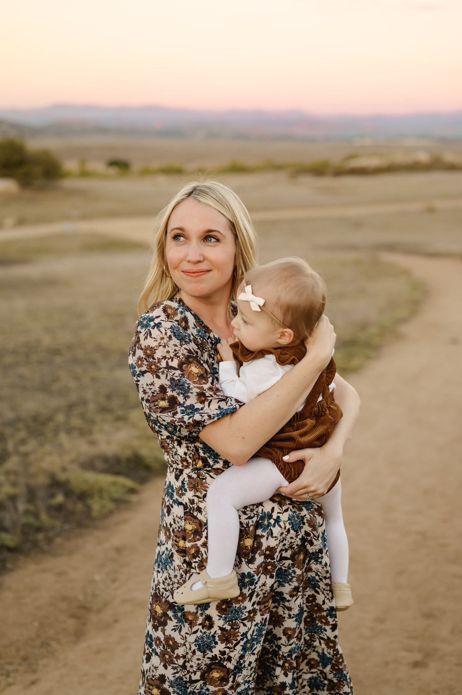 mom holding baby girl at Ramona Grasslands during mommy & me photoshoot by San Diego photographer, Tiffany Kelterer