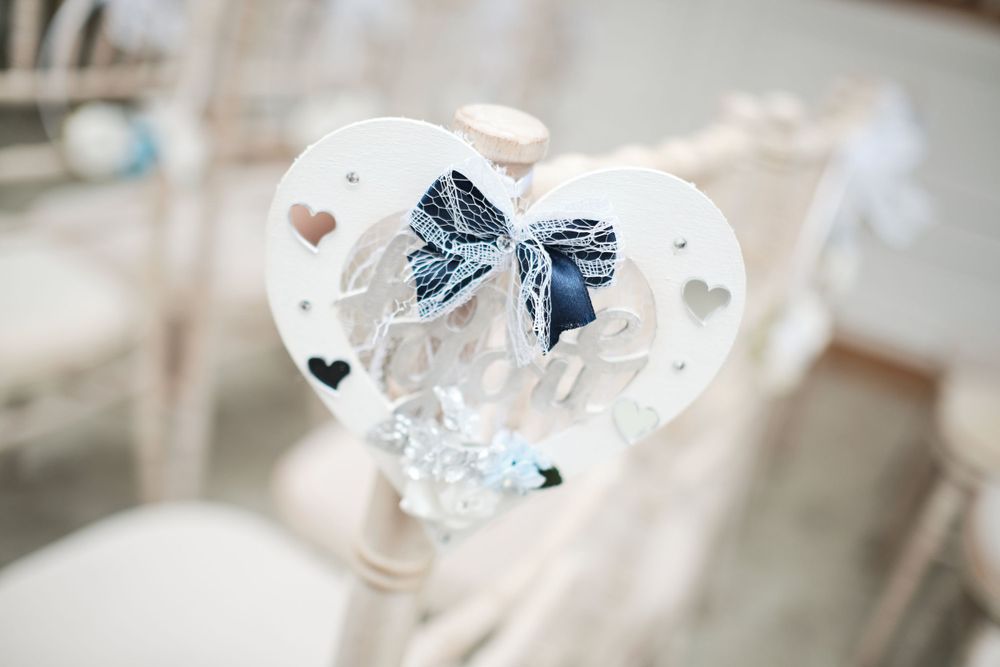 A delicate crystal heart ornament with a blue bow detail and cut-out hearts.