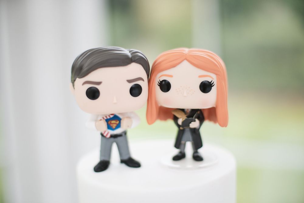 Close-up of custom Funko Pop bride and groom cake toppers.