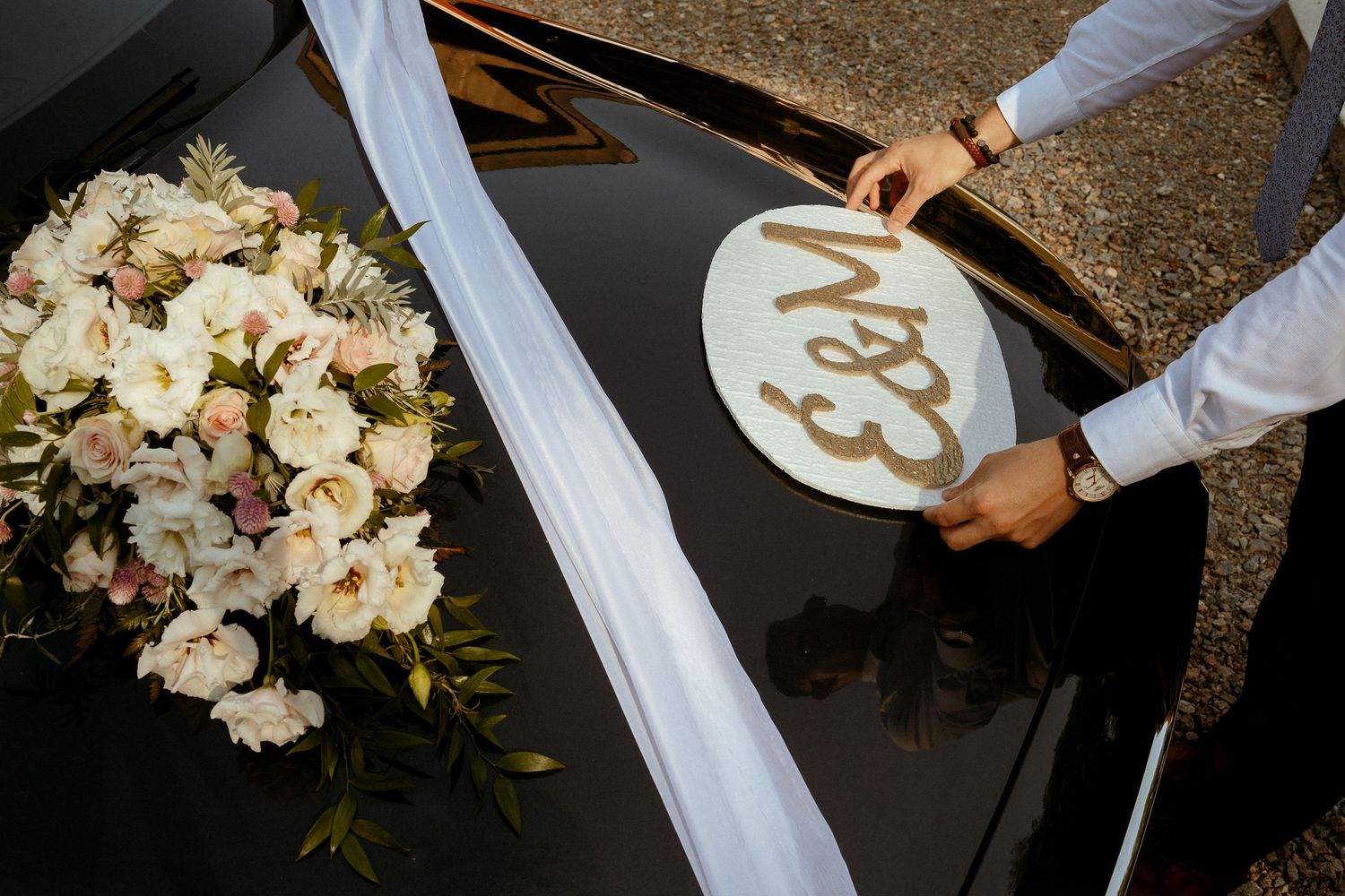 Wedding decor featuring a white floral arrangement and custom monogram display.