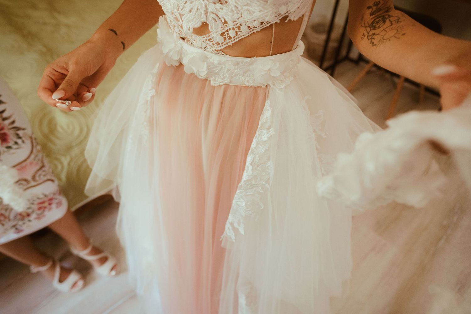 Close-up of delicate pink and white tulle wedding dress details.