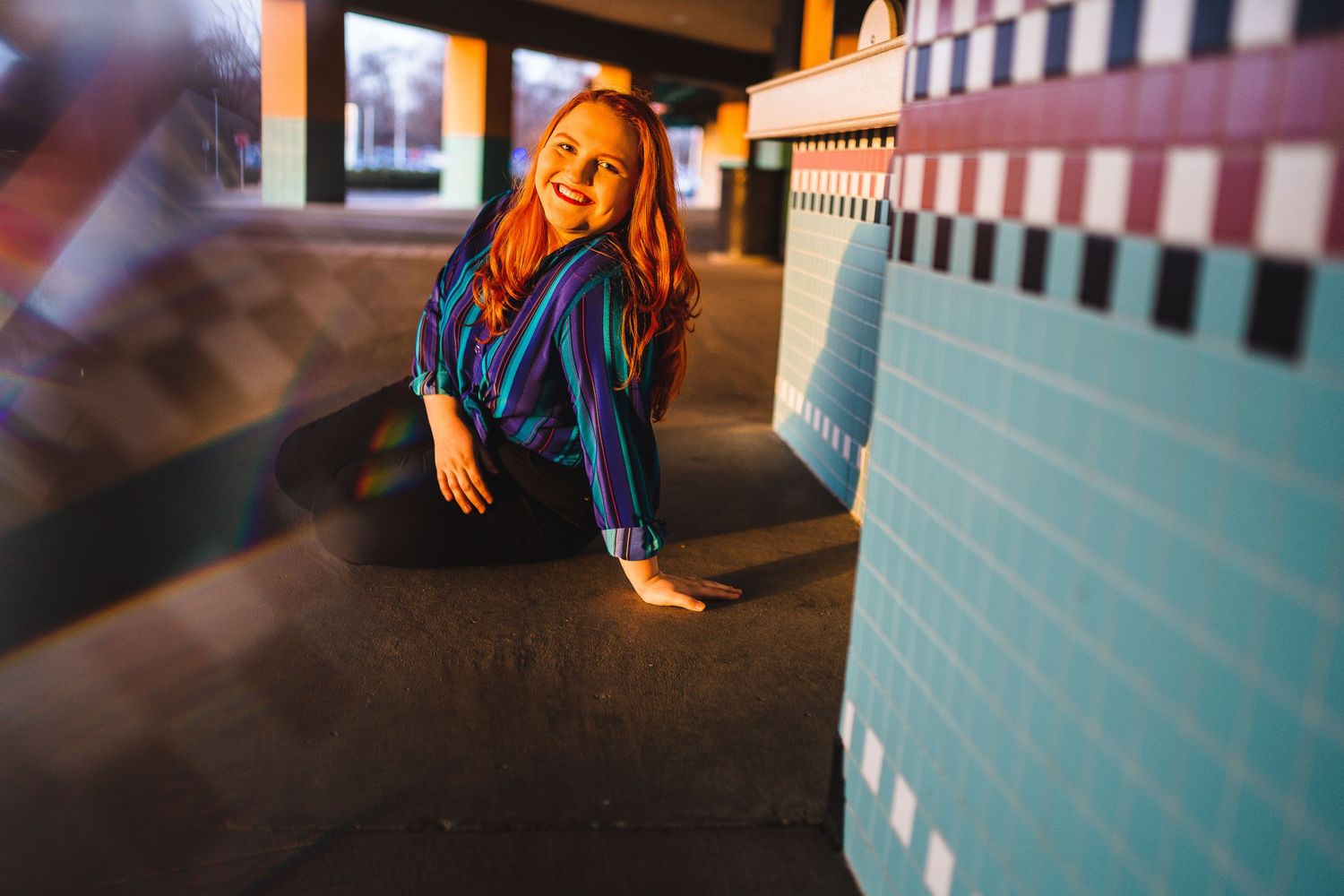Dancing figure in blue denim against geometric wall patterns.