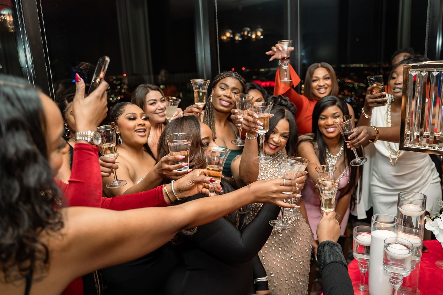 A lively celebration with friends toasting drinks at a festive party.