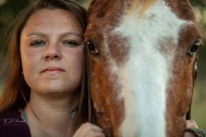 Close up portrait of a white and brown horse's face in natural lighting.