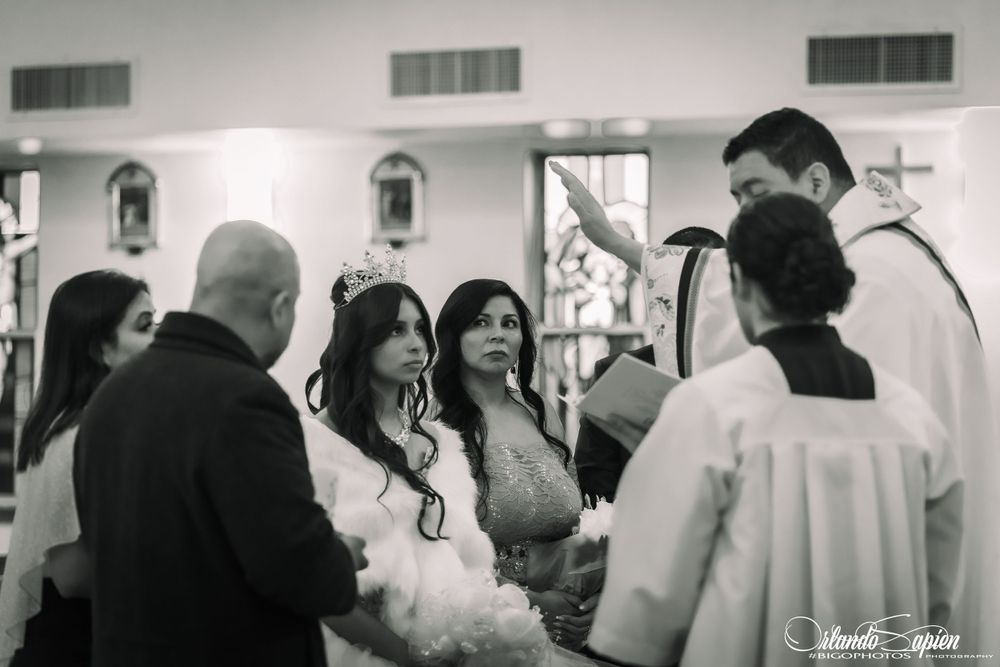A black and white photo of guests gathered at a formal church event.