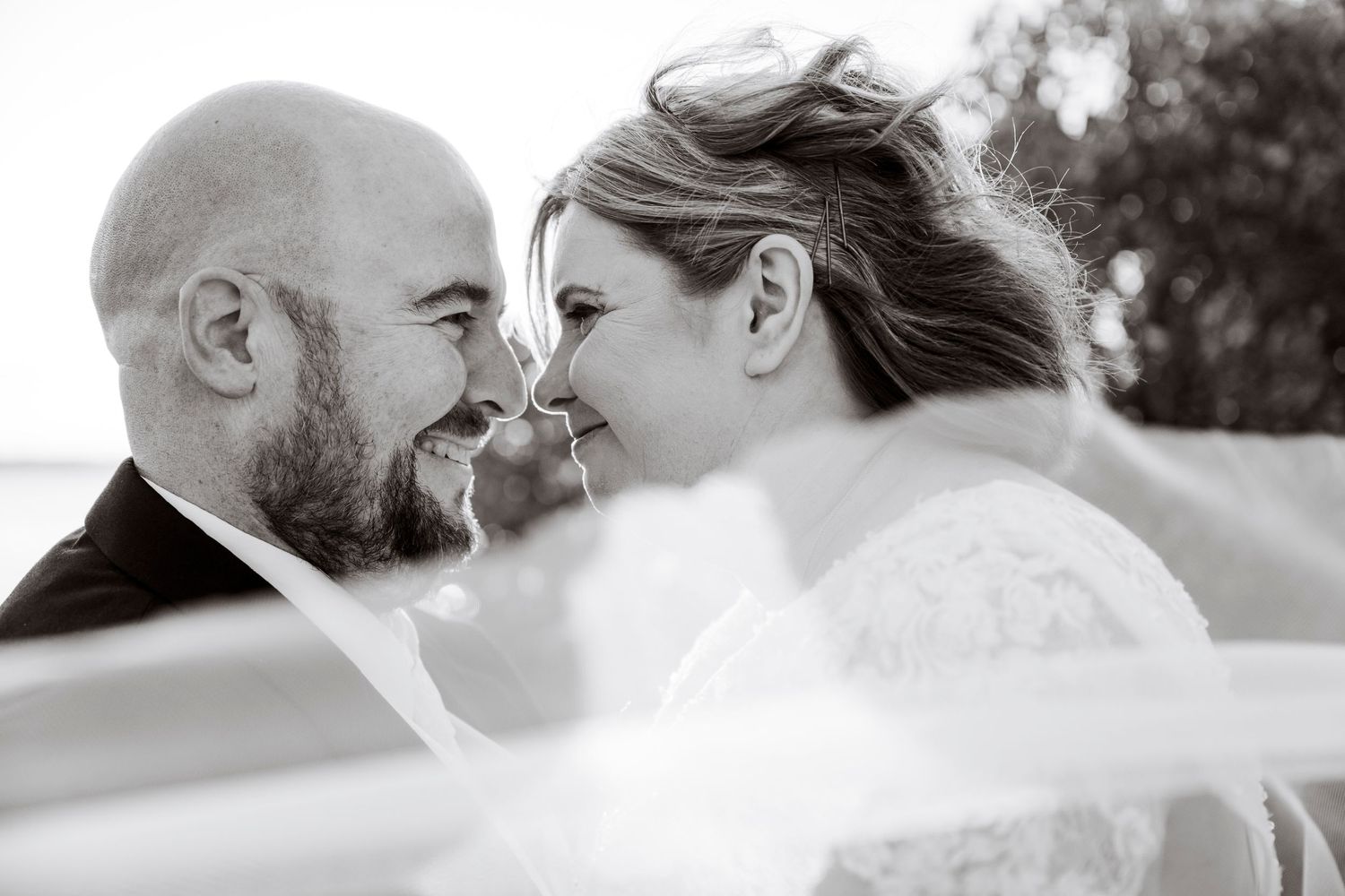 Intimate black and white portrait of couple sharing tender moment.