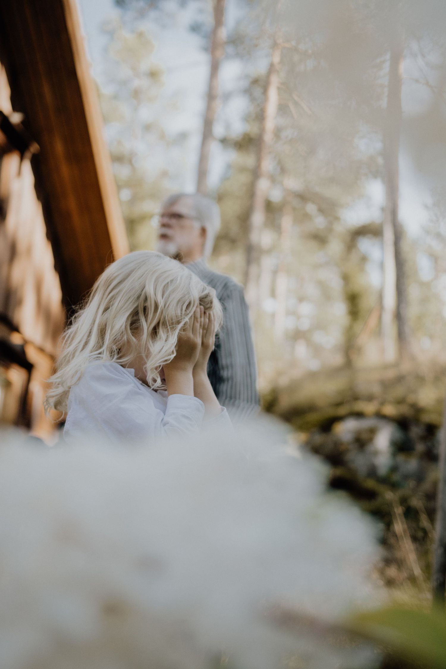 Artistic outdoor photography in a forest setting with soft natural lighting and bokeh effects.
