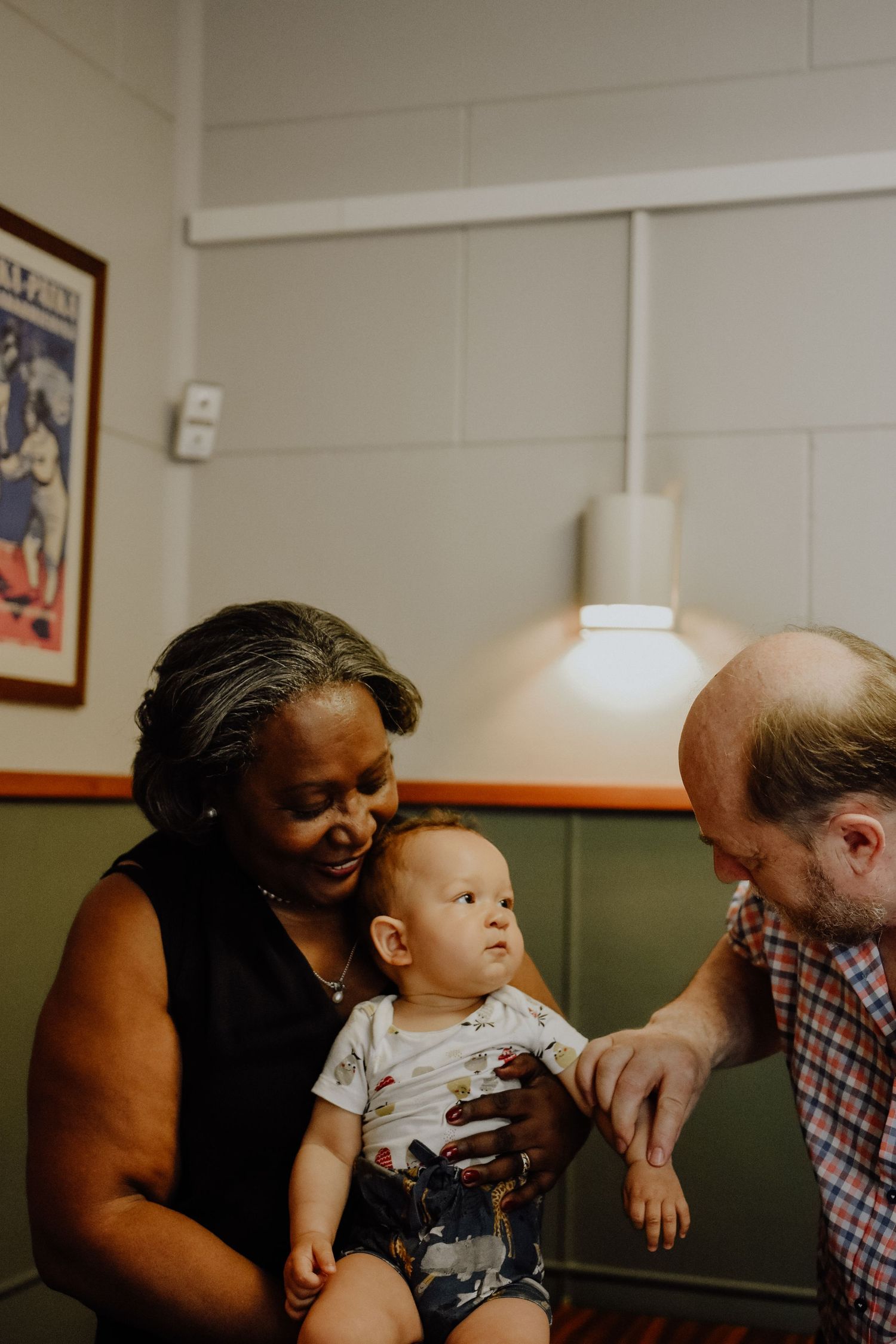 A warm family moment shared between multiple generations in an indoor setting.