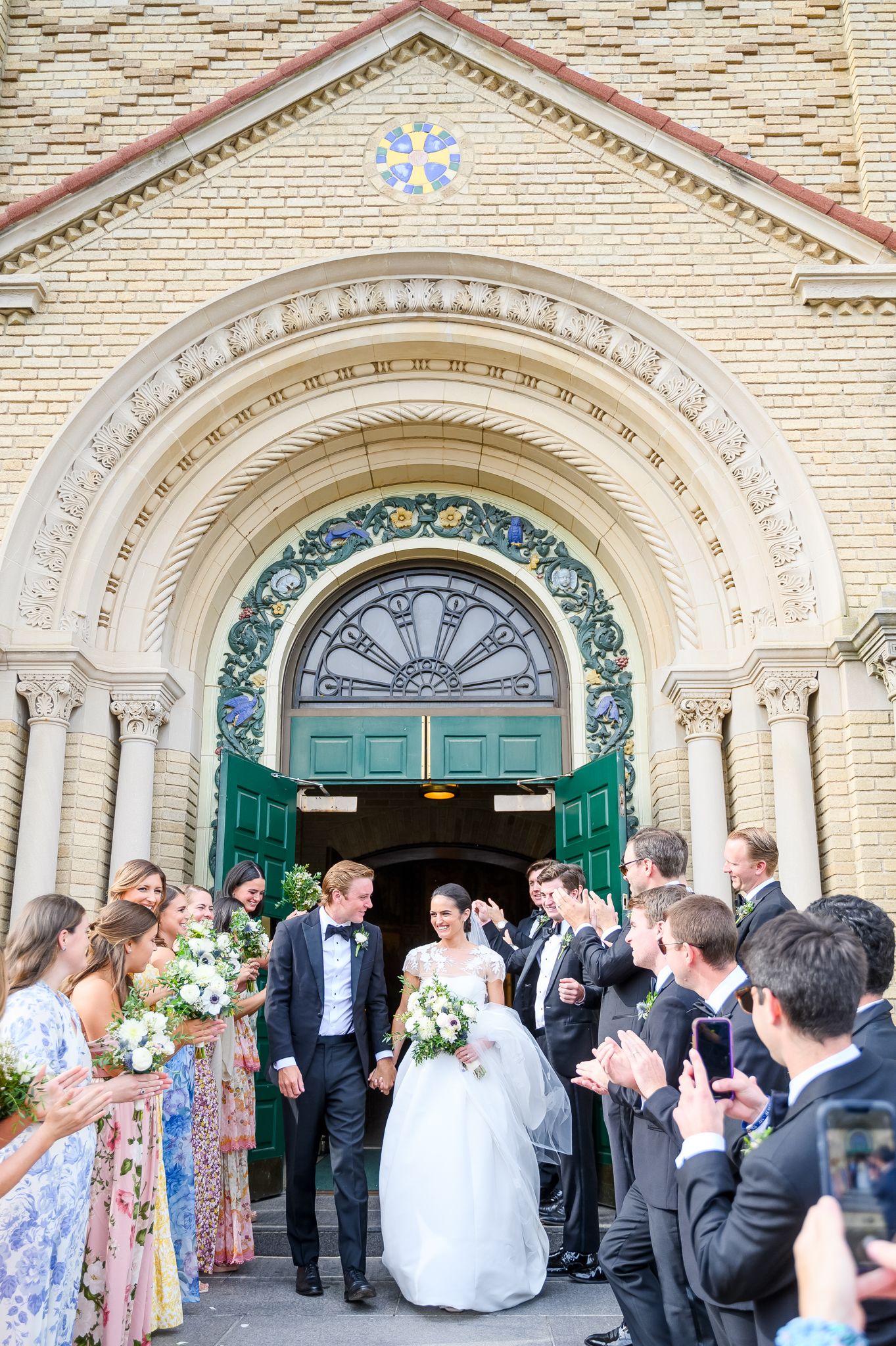 Excited couple holding hands as they exit the church.