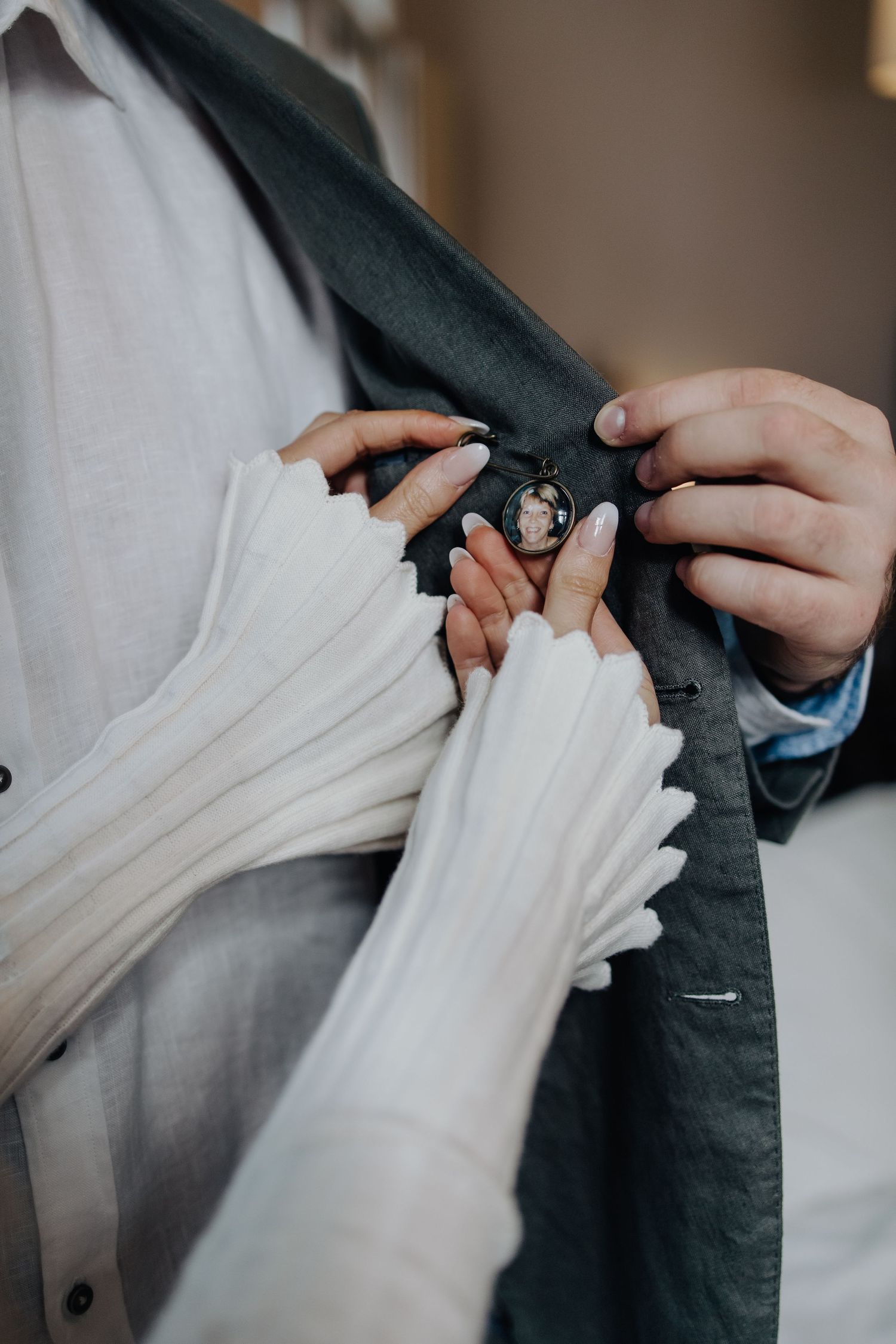 Close-up shots of folding white fabric against dark clothing showing texture and detail.