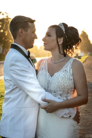 An intimate sunset wedding portrait capturing a tender moment between newlyweds.