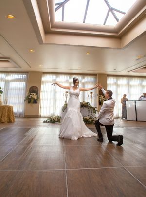 A wedding dress fitting session in an elegant room with natural skylight.