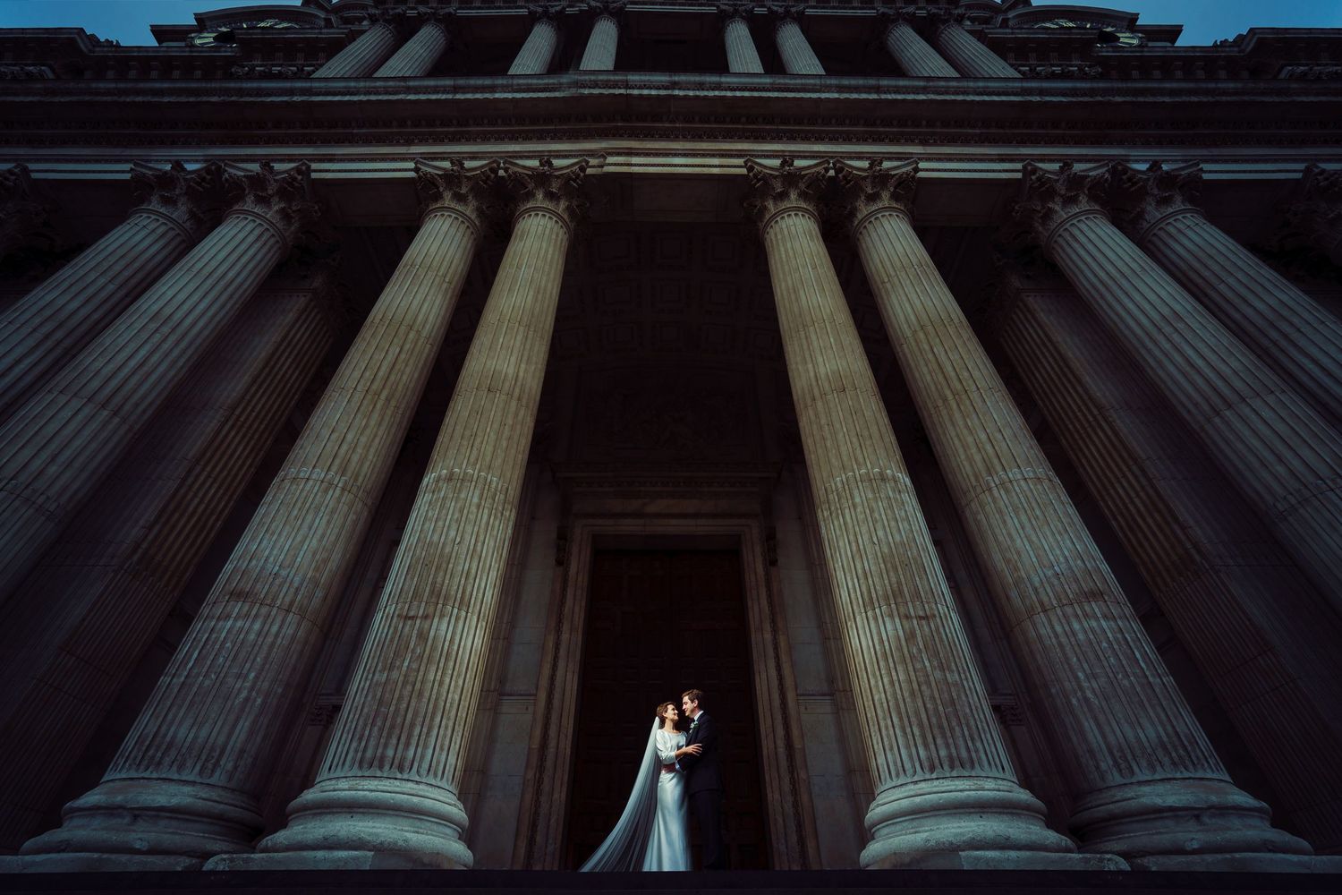 Couple on the steps of Saint Paul's Cathedral, between soaring columns