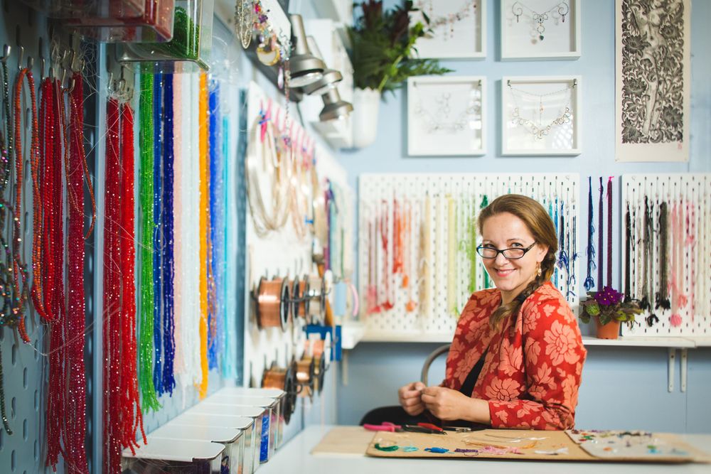 Modern creative workspace with vibrant wall decorations and hanging art installations.