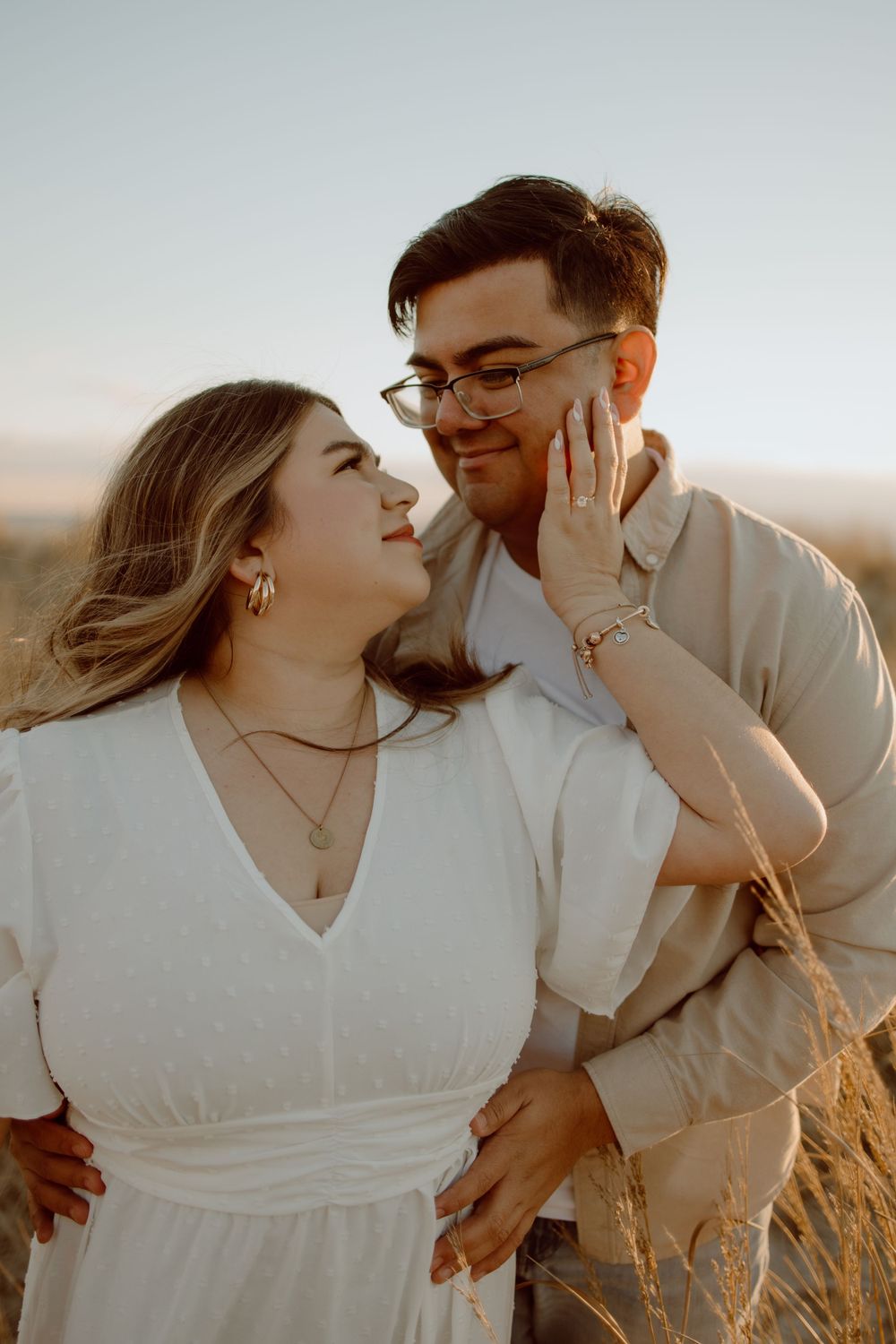A joyful sunset portrait with warm golden light and natural coastal scenery.